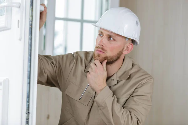 Young Handsome Builder Thinking Something While Holding Clipboard — Stock Photo, Image