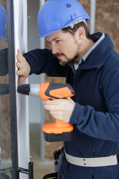 Man Drill Plastic Window — Stock Photo, Image