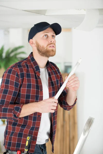 Male Electrician Clipboard Repairing Kitchen Extractor — Stock Photo, Image