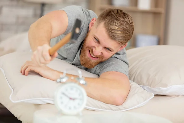 Young Man Tries Break Alarm Clock Hammer — Stock Photo, Image