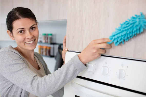 Χαρούμενη Νεαρή Γυναίκα Καθαρίζει Την Κουζίνα Στο Σπίτι — Φωτογραφία Αρχείου