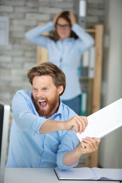 Angry Worker Destroying His Computer Keyboard — Stock Photo, Image