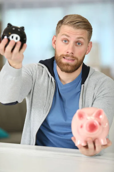 Happy Young Man Unsure Piggy Bank — Stock Photo, Image