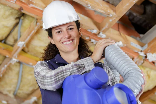 plumber woman builder fixing heating system pipes
