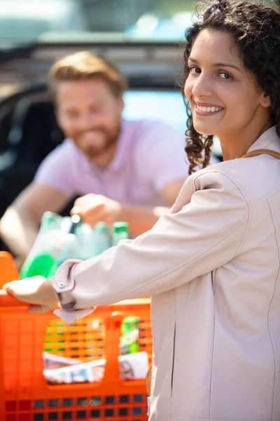 妇女与购物车在超市附近的停车场 — 图库照片
