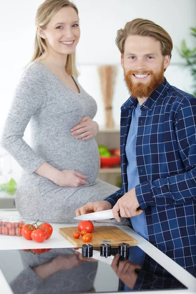 キッチンで幸せな妊娠中のカップルの肖像画 — ストック写真