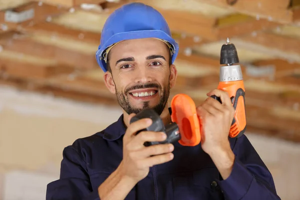 Happy Engineer Charging Battery His Drill — Stock Photo, Image