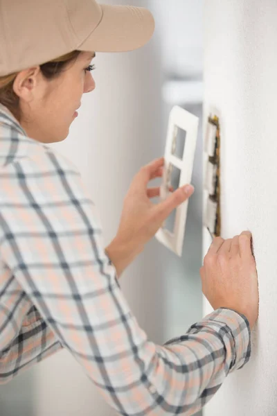 Woman Repairing Broken Electrical Outlet — Stock Photo, Image