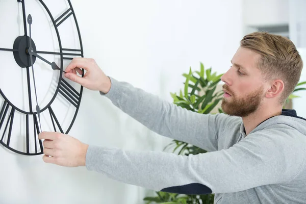 Young Man Setting Large Mechanical Clock — Stock Photo, Image