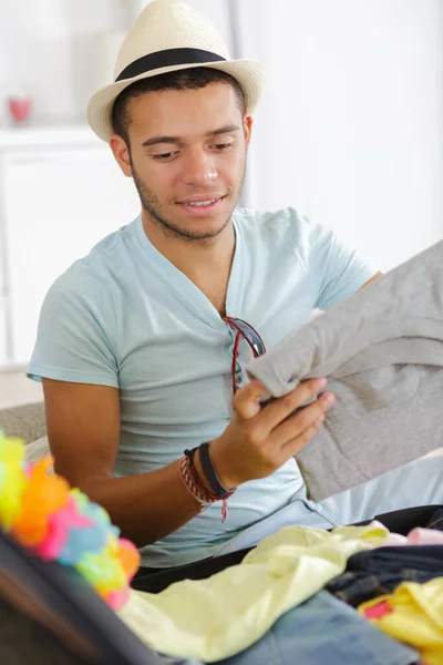 Young Man Packing Suitcase — Stock Photo, Image