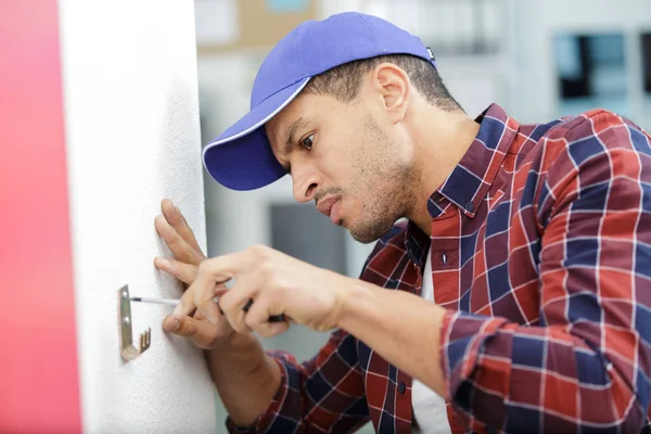 Young Working Man Fixing Clothes Hook Wall — Stock Photo, Image