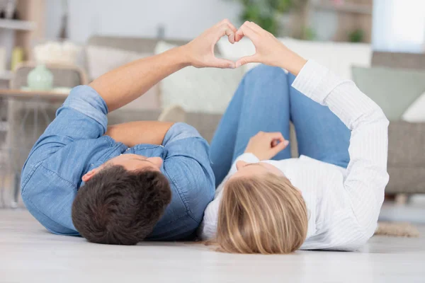 自宅の床に座って幸せな若いカップル — ストック写真