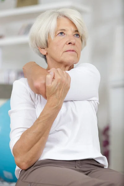 Elderly Woman Stretching Arm — Stock Photo, Image