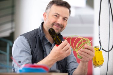 electrician engineer works with electric wires clipart