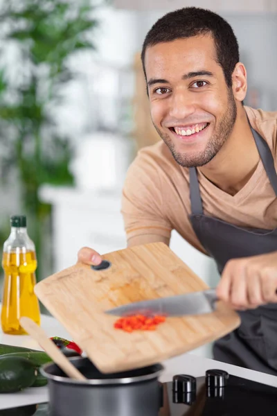 Young Man Smiling Slides Vegetables Pan — Stock Photo, Image