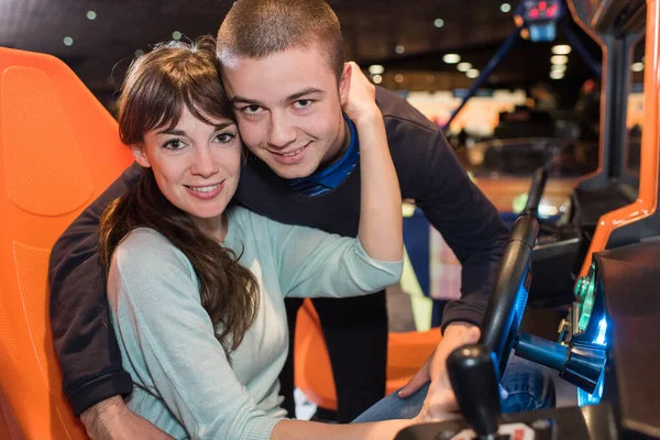 Young Teenage Couple Sitting Arcade Game — Stock Photo, Image