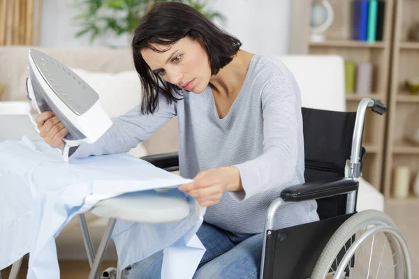 Young Woman Wheelchair Irons Clothes — Stock Photo, Image