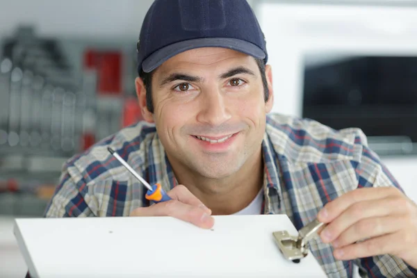 Satisfied Carpenter Tightening Screws — Stock Photo, Image