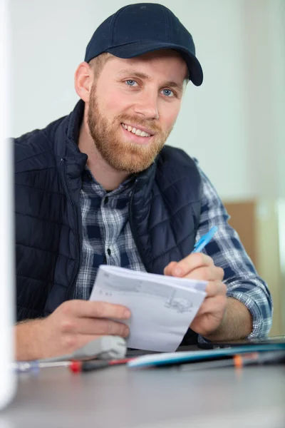 Young Male Repairman Checking Appliance Manual — Stock Photo, Image