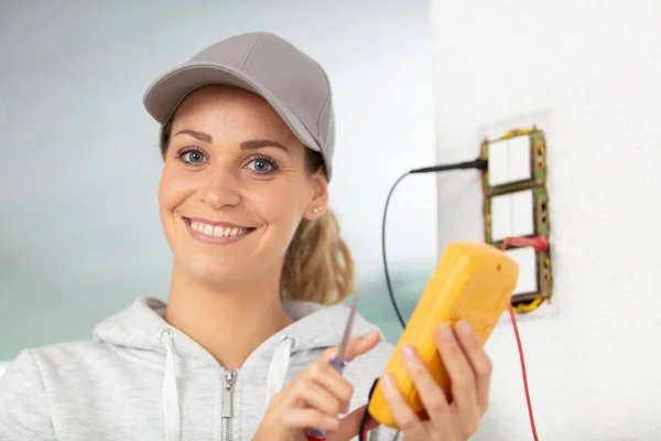 Eletricista Feminino Usando Medidor Para Interruptor Luz — Fotografia de Stock