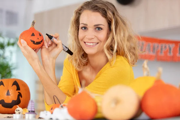Beautiful Young Woman Decorating Pumpkin Smiling — Stock Photo, Image