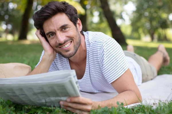 Young Man Reading Newspaper Bench Outdoors — Stock Photo, Image