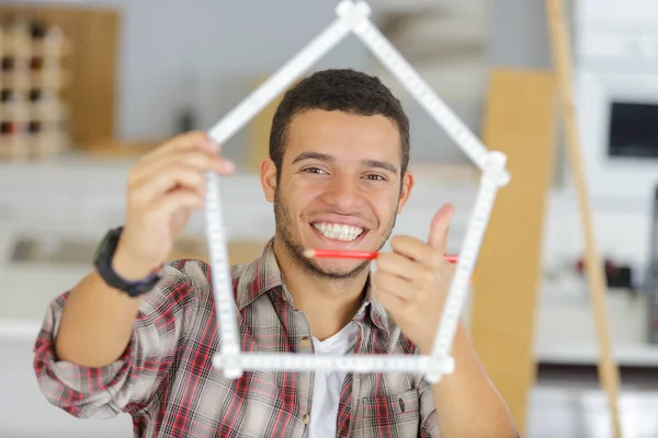 Young Man Looking Ruler Bent House Shape — Stock Photo, Image
