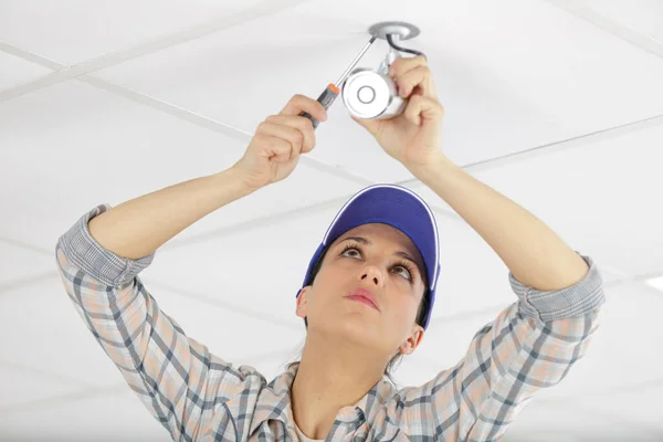 Female Worker Changing Spotlight Ceiling — Stock Photo, Image