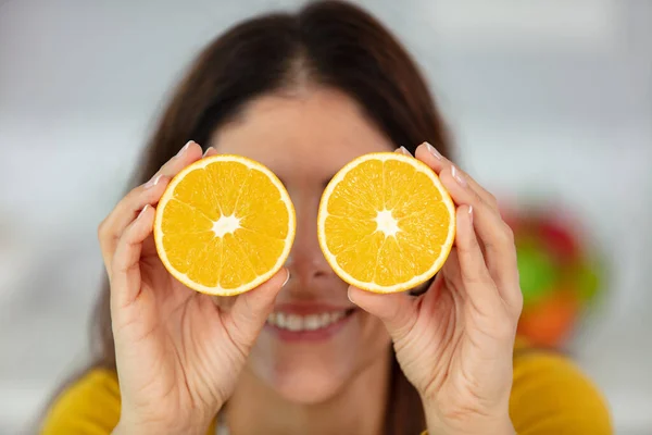 Cheerful Young Girl Holding Orange Halves Her Eyes — Stock Photo, Image