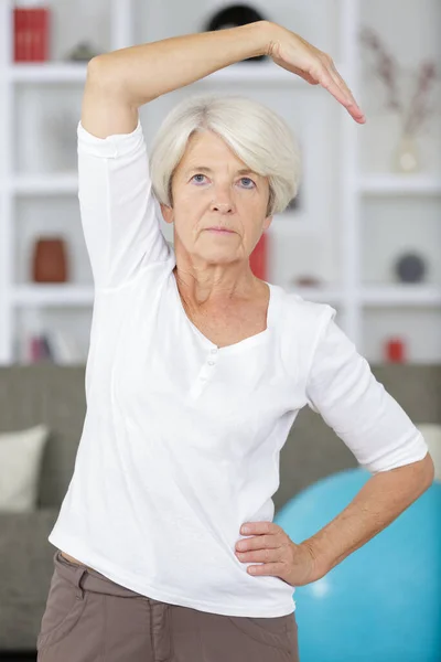 快乐的老年妇女在家锻炼 — 图库照片