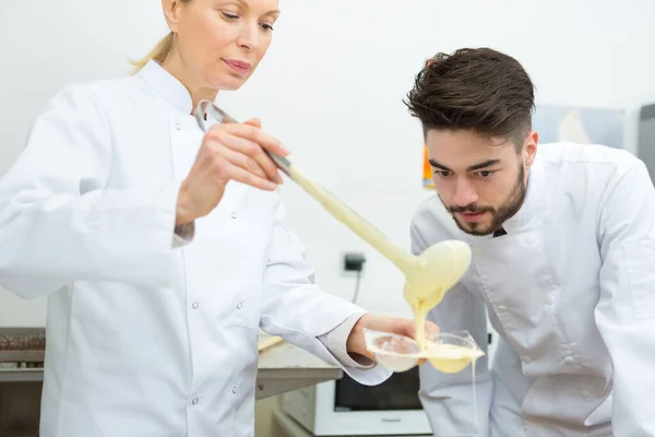 Chef Watching Colleague Pouring Chocolate Mould — Stock Photo, Image