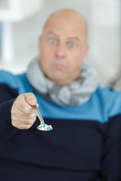 Homem Comendo Pílulas Com Uma Colher — Fotografia de Stock