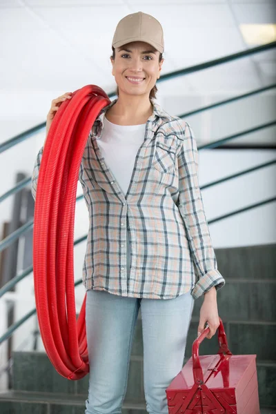 Happy Female Worker Holding Ventilation Pipes — Foto Stock