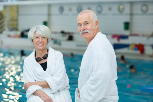 Loving Senior Couple Bathrobe Swimming Pool — Stock Photo, Image