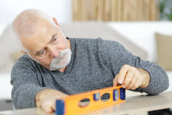Senior Man Measuring Furniture — Stock Photo, Image