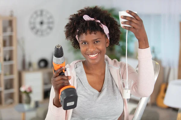 Excited Young African Woman Holding Electric Drill — Stock Photo, Image