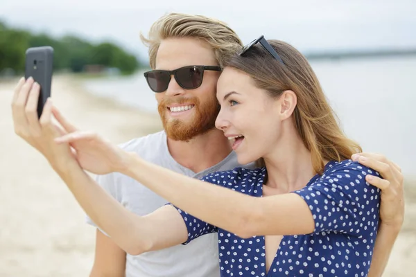 Casually Ντυμένο Ζευγάρι Βγάζει Selfie Στην Παραλία — Φωτογραφία Αρχείου