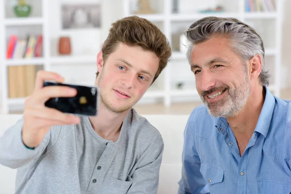 Adolescent Boy Talking Photo Himself His Father — Stock Photo, Image