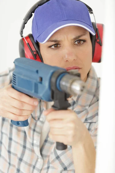 Serious Woman Drilling Wall New House — Stockfoto