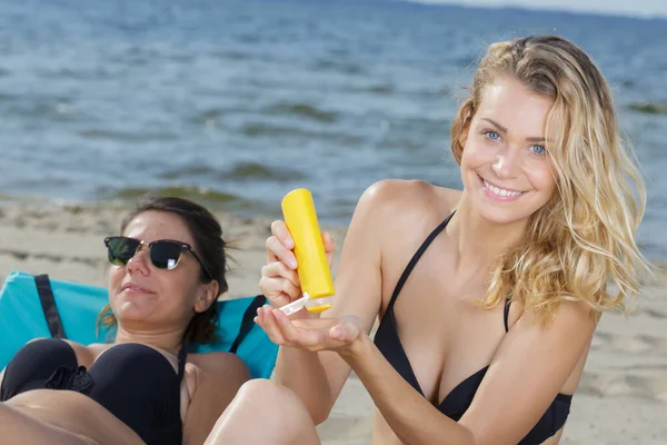 Woman Holding Sunscreen Beach — Stockfoto