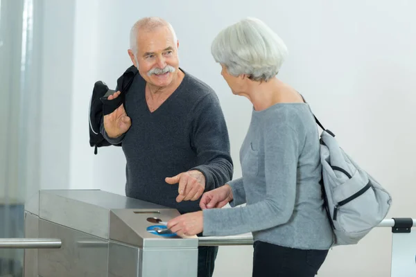 stock image elderly woman scanning her card on entrance