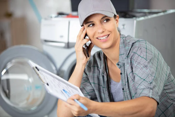 在家里修理洗衣机的女承包商 — 图库照片
