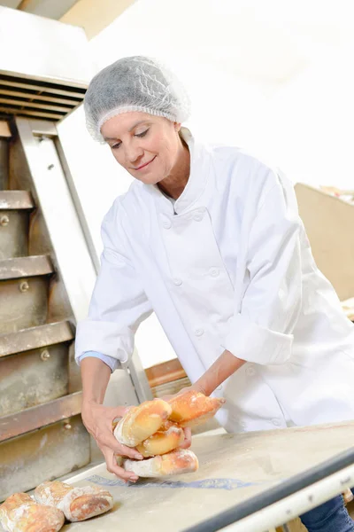 Female Baker Holding Bread Sticks — Stock Photo, Image