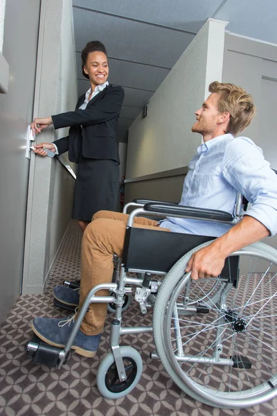 Obchodník Invalidním Vozíku Recepční Ukazující Svůj Pokoj — Stock fotografie