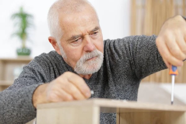 Mature Man Hand Screwing Furniture — Stock Photo, Image