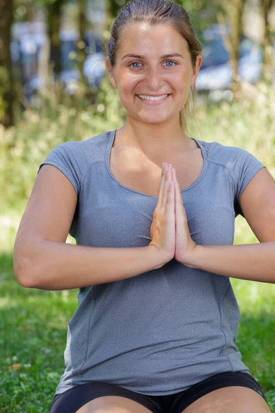 一个快乐的年轻女子在户外做瑜伽 — 图库照片