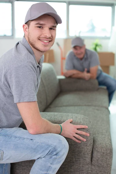 Removals Men Carrying Sofa Showing Thumbs — Stok fotoğraf