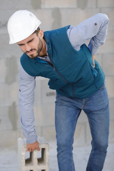 Young Construction Worker Getting Back Injury — Stock Photo, Image