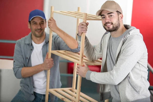 Two Men Coworkers Carry Wood Shelf — Stock Photo, Image