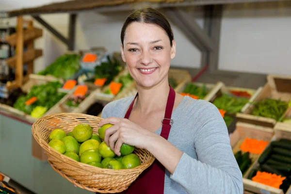 Female Smiling Greengrocer Holding Basket Lemons — Stock Photo, Image